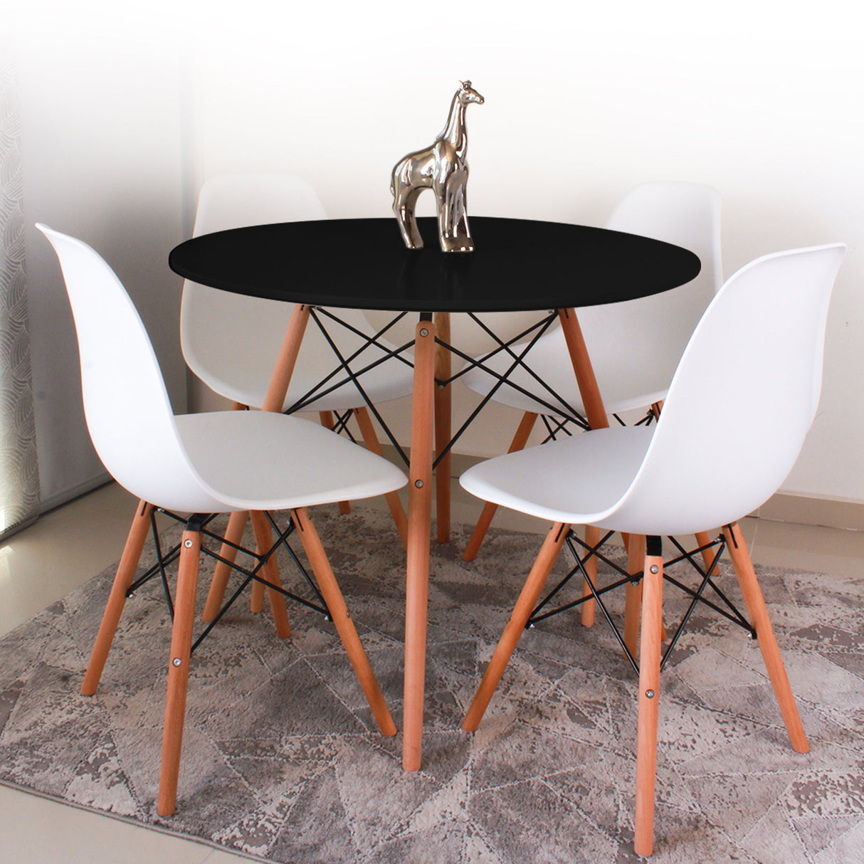 COMEDOR REDONDO TAPA NEGRA MÁS 4 SILLAS DKR TIPO EAMES BLANCAS